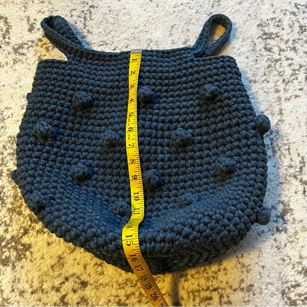 Hand-crocheted blue tote bag with bobble stitch details.